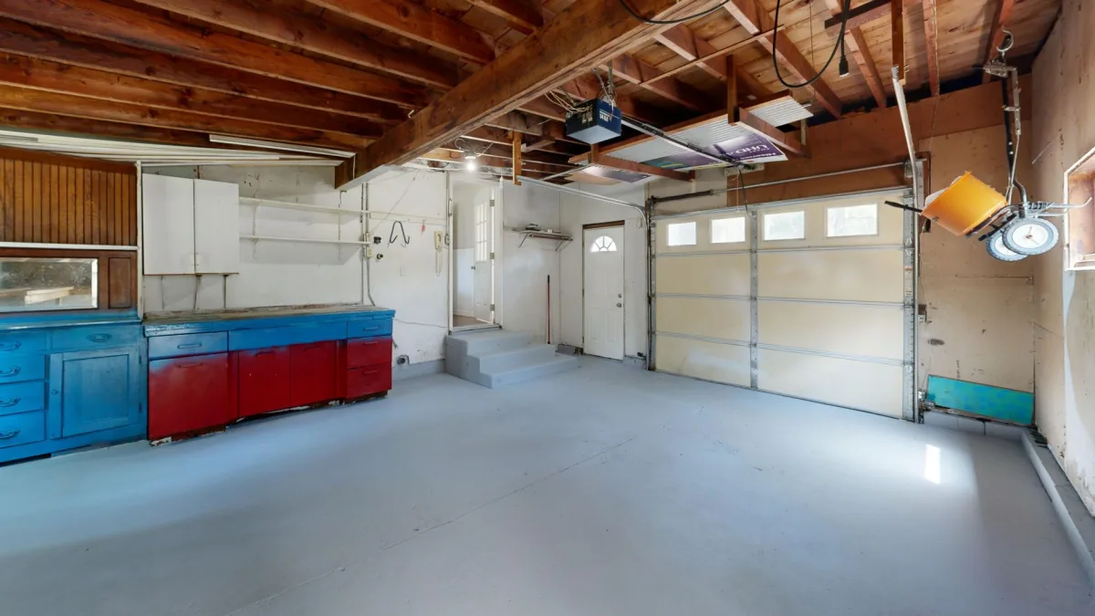 Garage interior with a plain poured concrete floor and a sectional door
