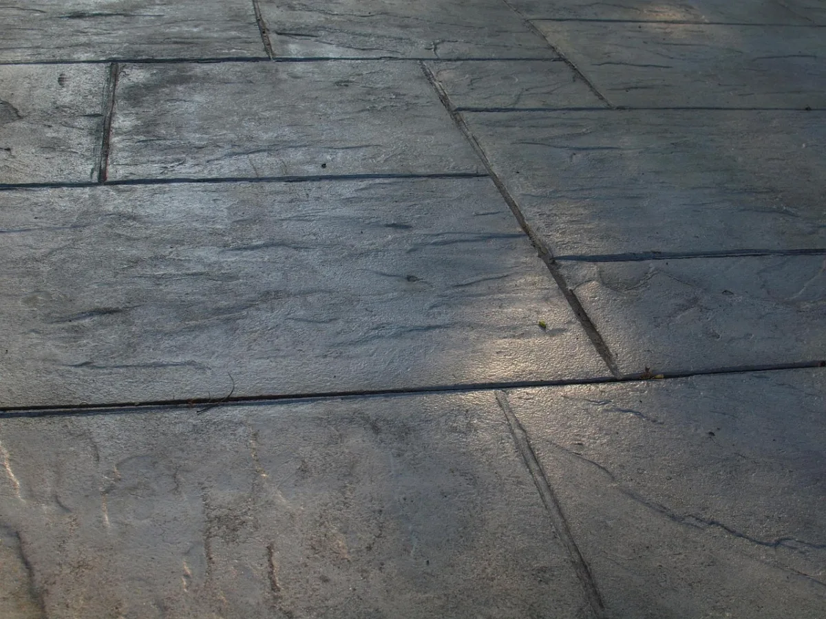 Stamped concrete patio surface in a slate pattern with tooled joints
